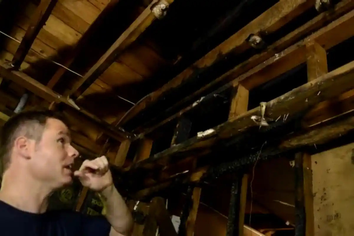 Charred roof framing inspection after a house fire in Westbury NY