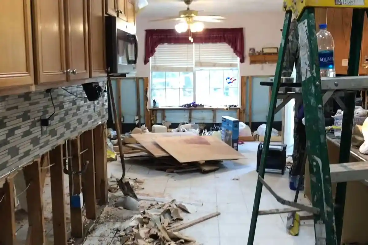 Water damage repair with drywall removed during flood cut restoration in a Westbury NY kitchen